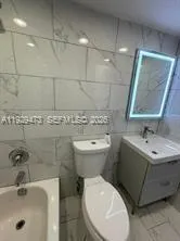 a bathroom with a sink toilet and mirror