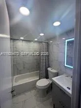 a bathroom with a toilet a sink and shower