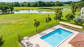 a view of a swimming pool with a yard