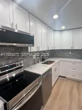 a kitchen that has a sink and a stove