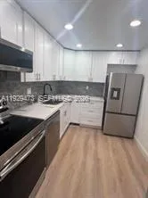 a kitchen with stainless steel appliances granite countertop a sink and a stove