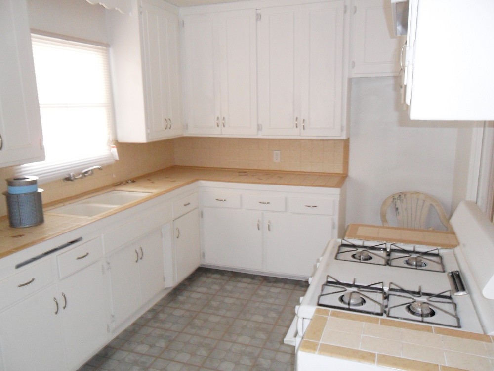 3608 Post Street Riverside, CA 92501 - Photo 2 of 5 a kitchen with a stove and white cabinets