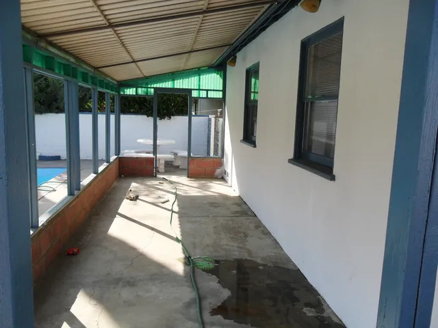 a view of a house with a backyard and porch