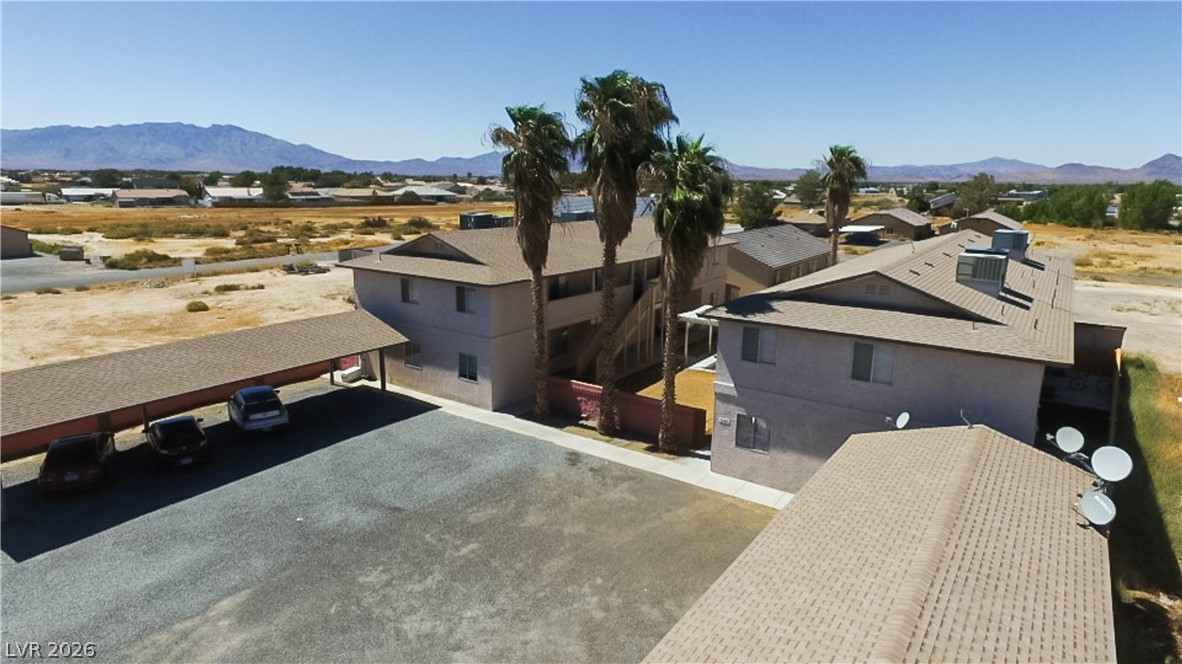 1444 Star Road Pahrump, NV 89048 - Photo 28 of 37 Distant mountains frame the clean exterior of these multi-family residential buildings.