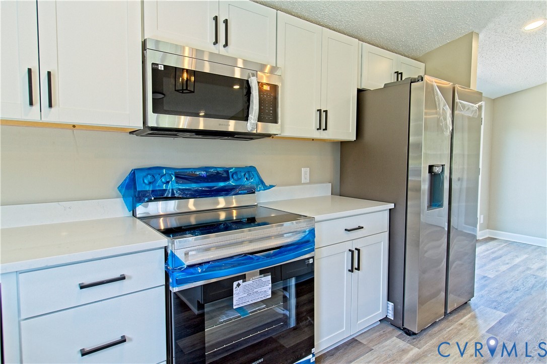 2110 Military Road Amelia Court House, VA 23002 - Photo 13 of 46 a kitchen with stainless steel appliances a stove microwave and refrigerator