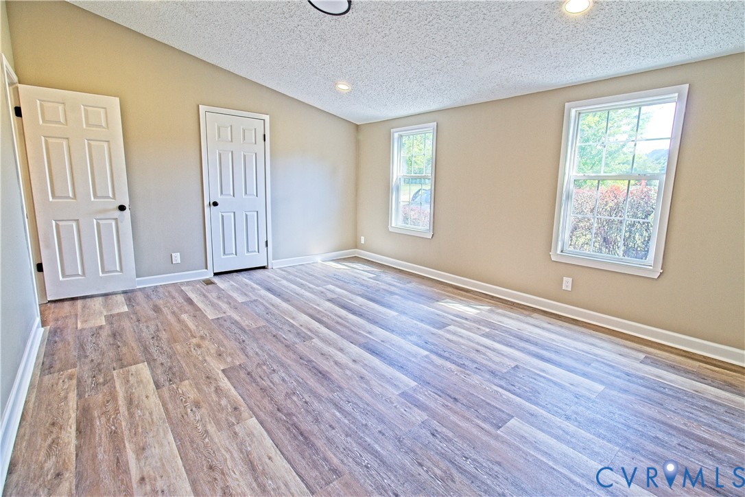 2110 Military Road Amelia Court House, VA 23002 - Photo 18 of 46 a view of an empty room with wooden floor and a window