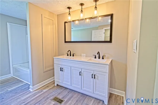 a spacious bathroom with a double vanity sink and a mirror