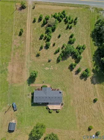 an aerial view of a house with a yard