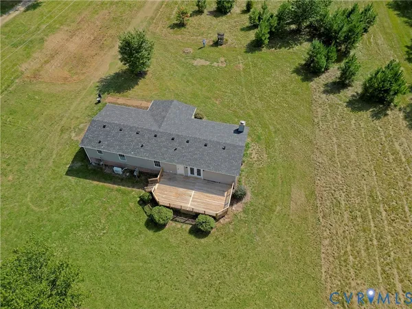 an aerial view of a house with a yard and lake view