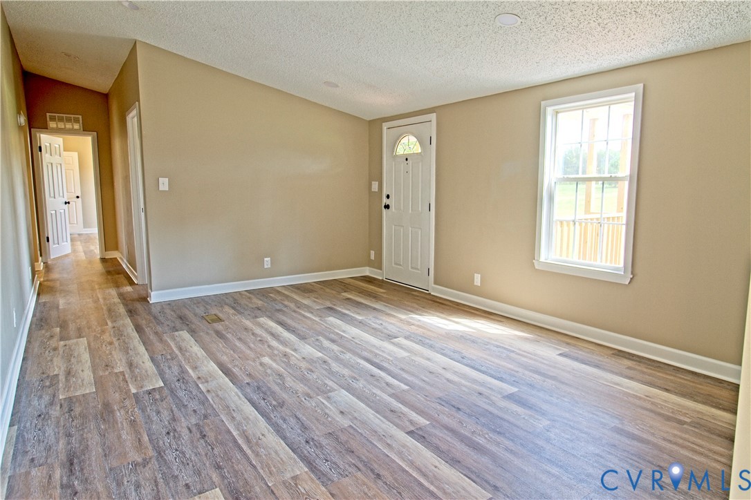 2110 Military Road Amelia Court House, VA 23002 - Photo 6 of 46 a view of an empty room with wooden floor and a window