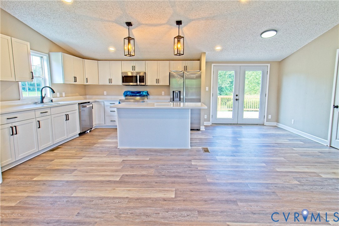 2110 Military Road Amelia Court House, VA 23002 - Photo 10 of 46 a large kitchen with cabinets wooden floor and a sink