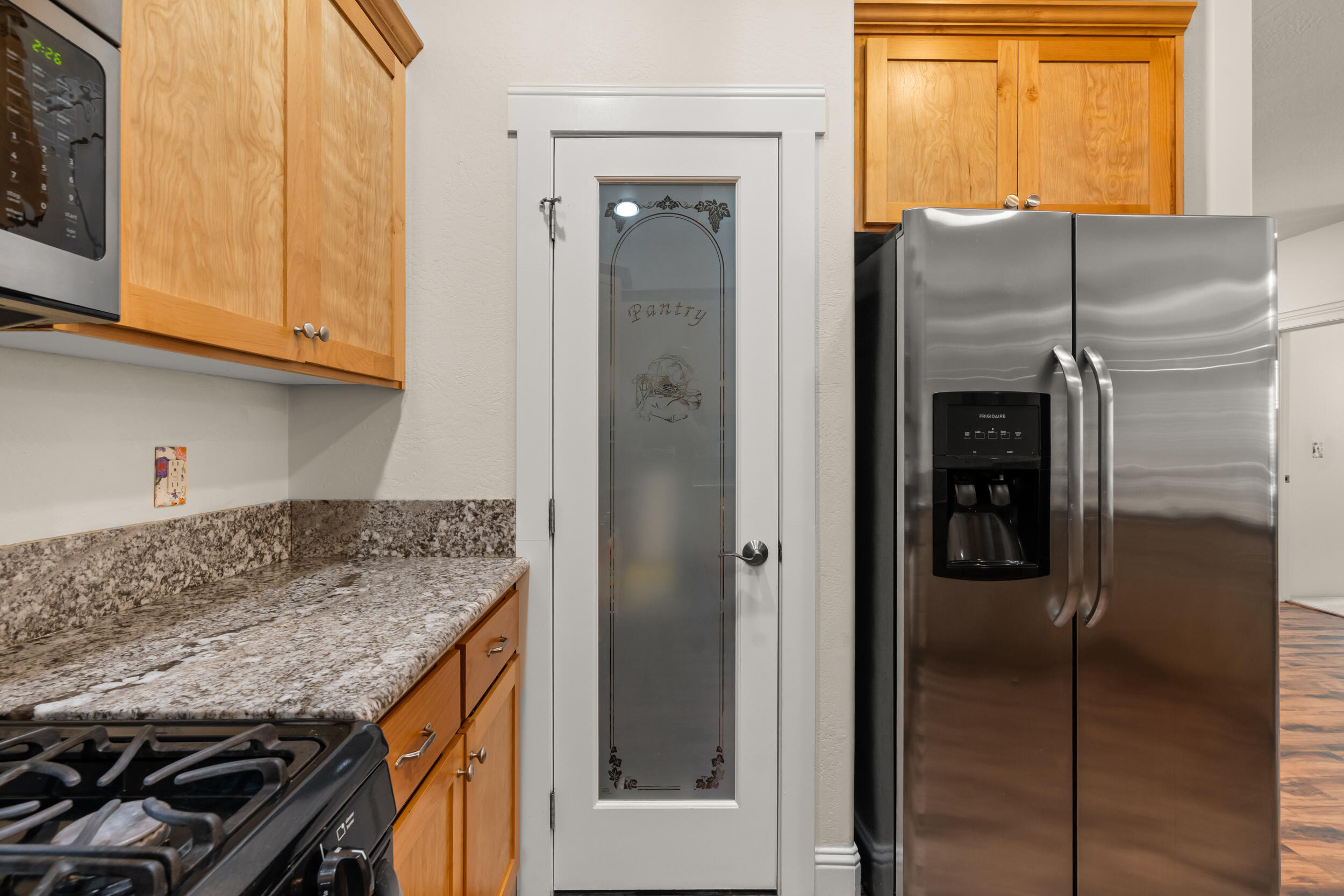 1227 Lithia Way Talent, OR 97540 - Photo 9 of 37 a kitchen with stainless steel appliances granite countertop a refrigerator and a sink