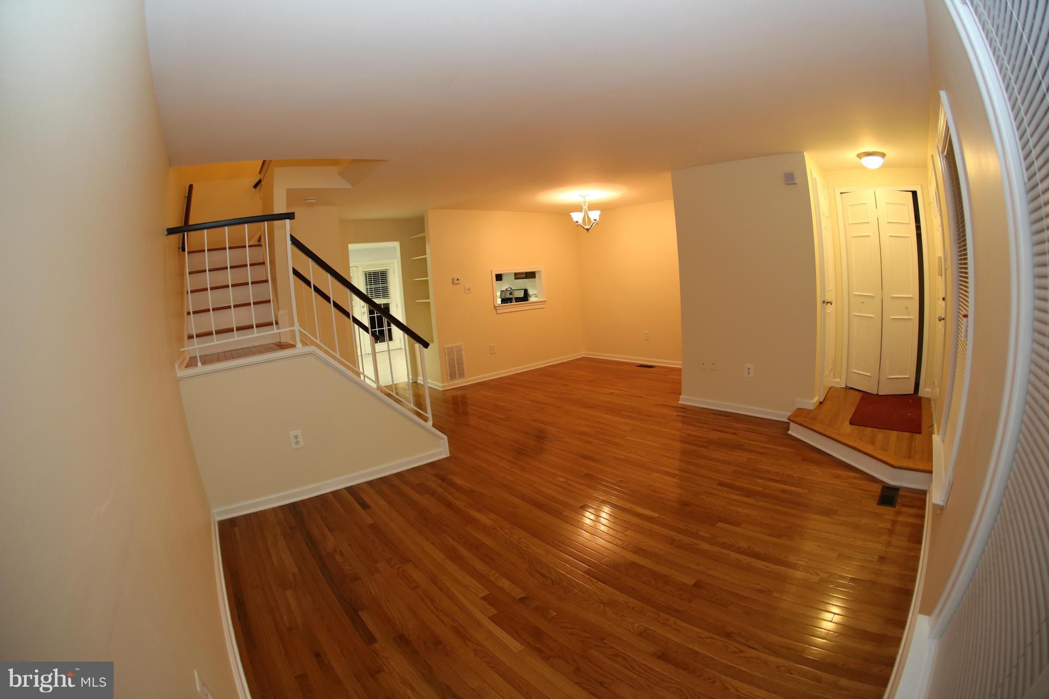 8046 Felecity Court Springfield, VA 22153 - Photo 2 of 26 a view of a hallway with wooden floor and staircase