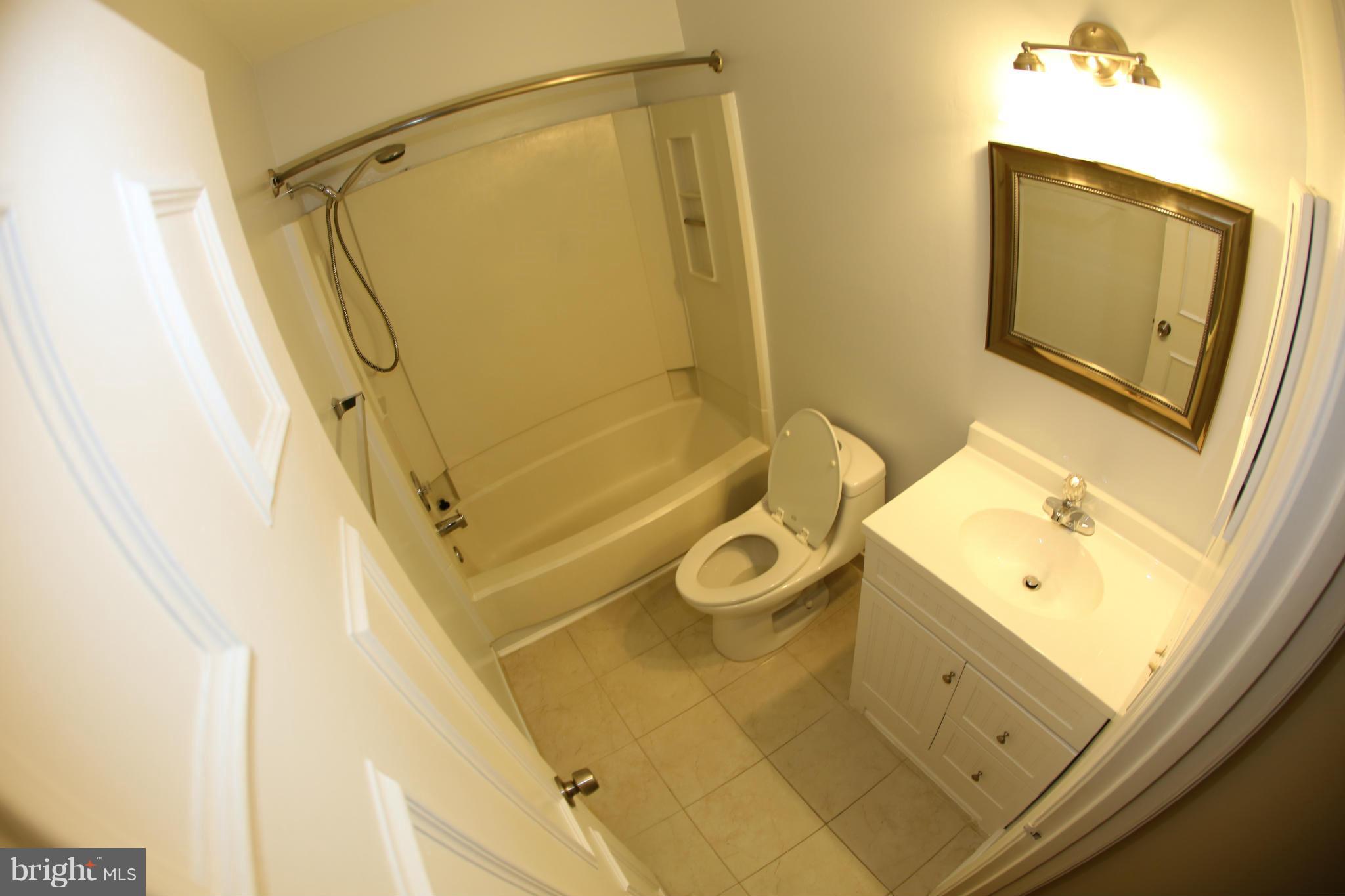 8046 Felecity Court Springfield, VA 22153 - Photo 15 of 26 a bathroom with a sink a mirror and a shower