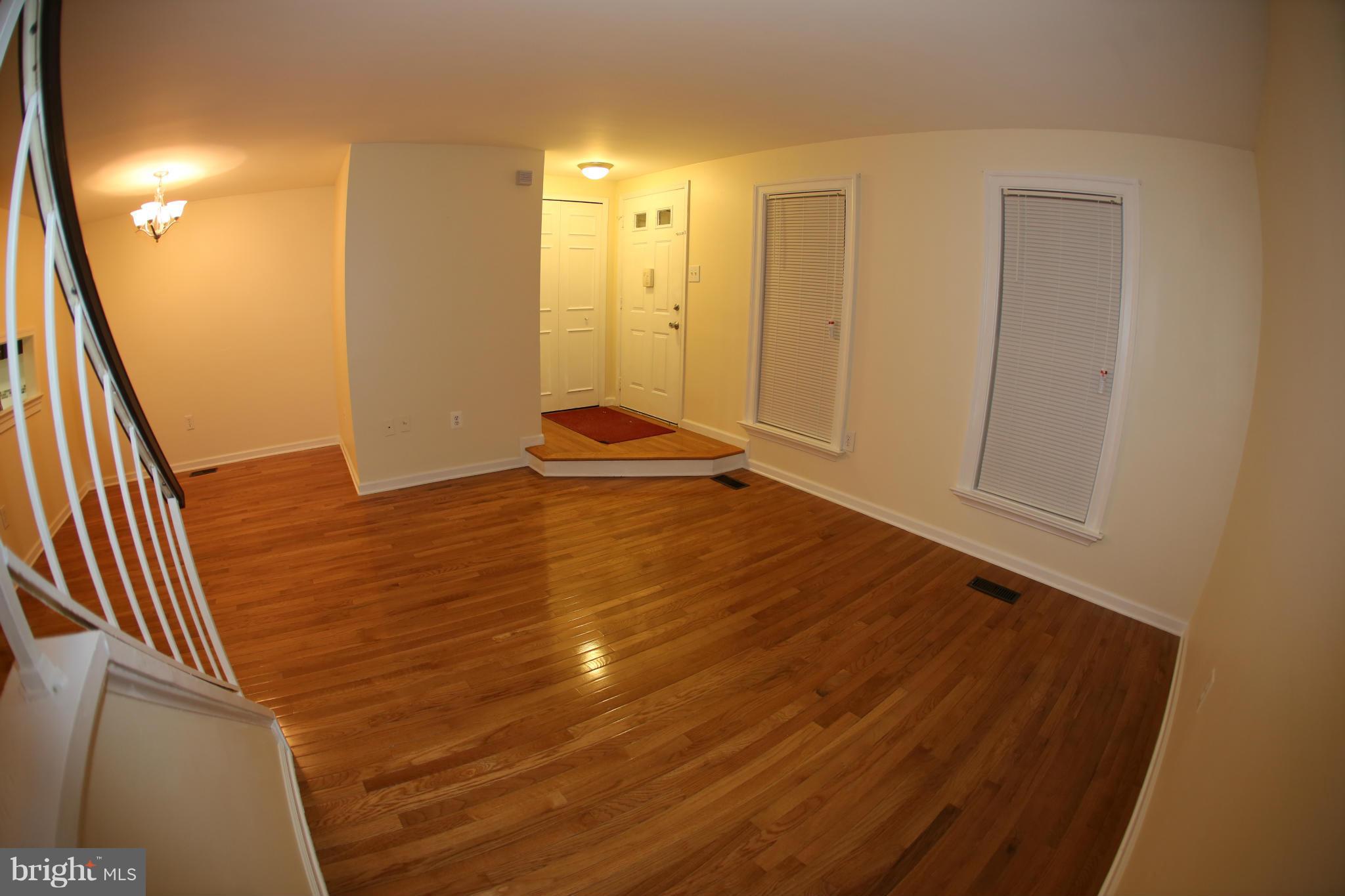 8046 Felecity Court Springfield, VA 22153 - Photo 3 of 26 a view of an empty room with wooden floor and a bathroom