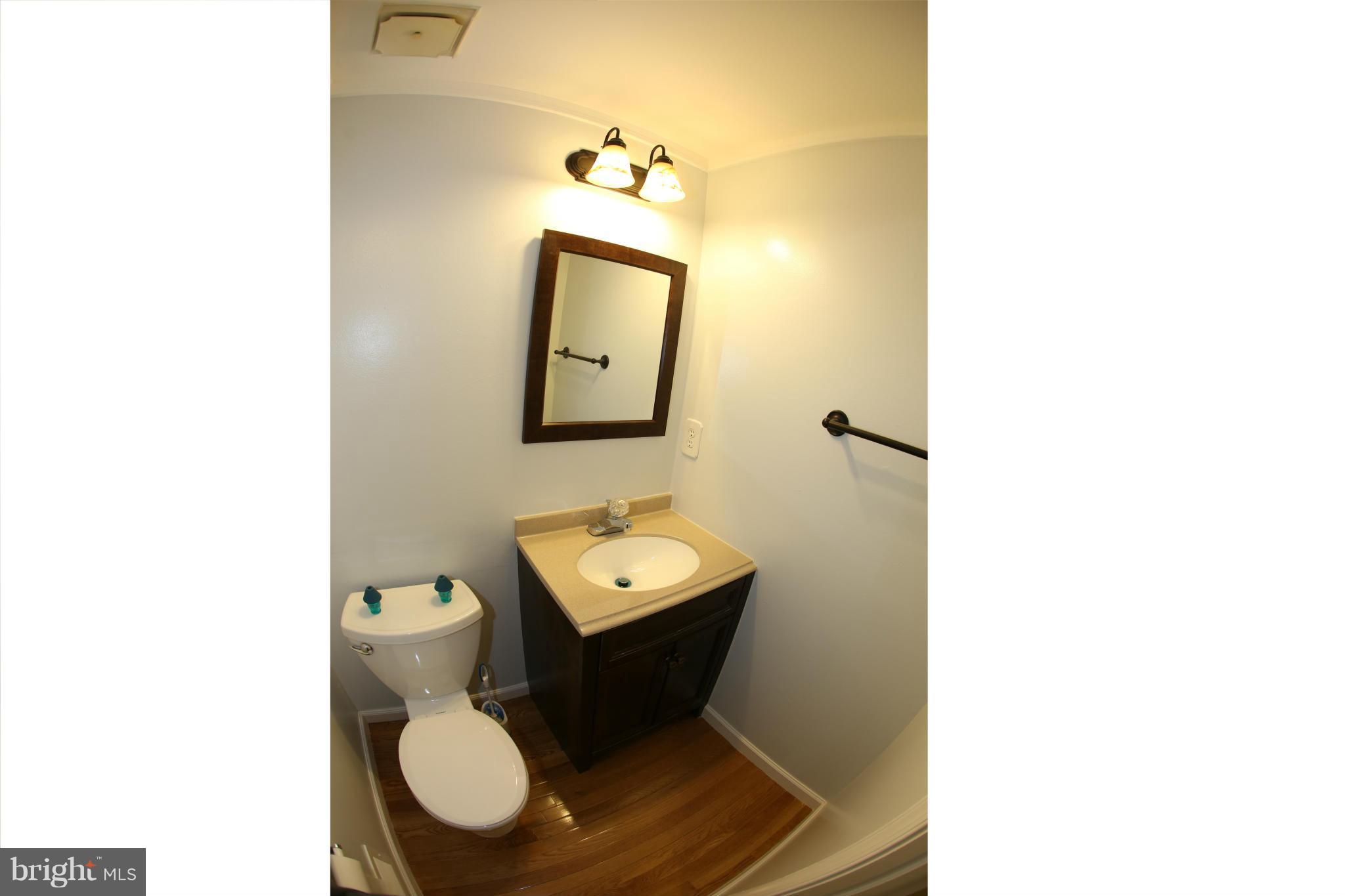 8046 Felecity Court Springfield, VA 22153 - Photo 22 of 26 a bathroom with a toilet sink and mirror