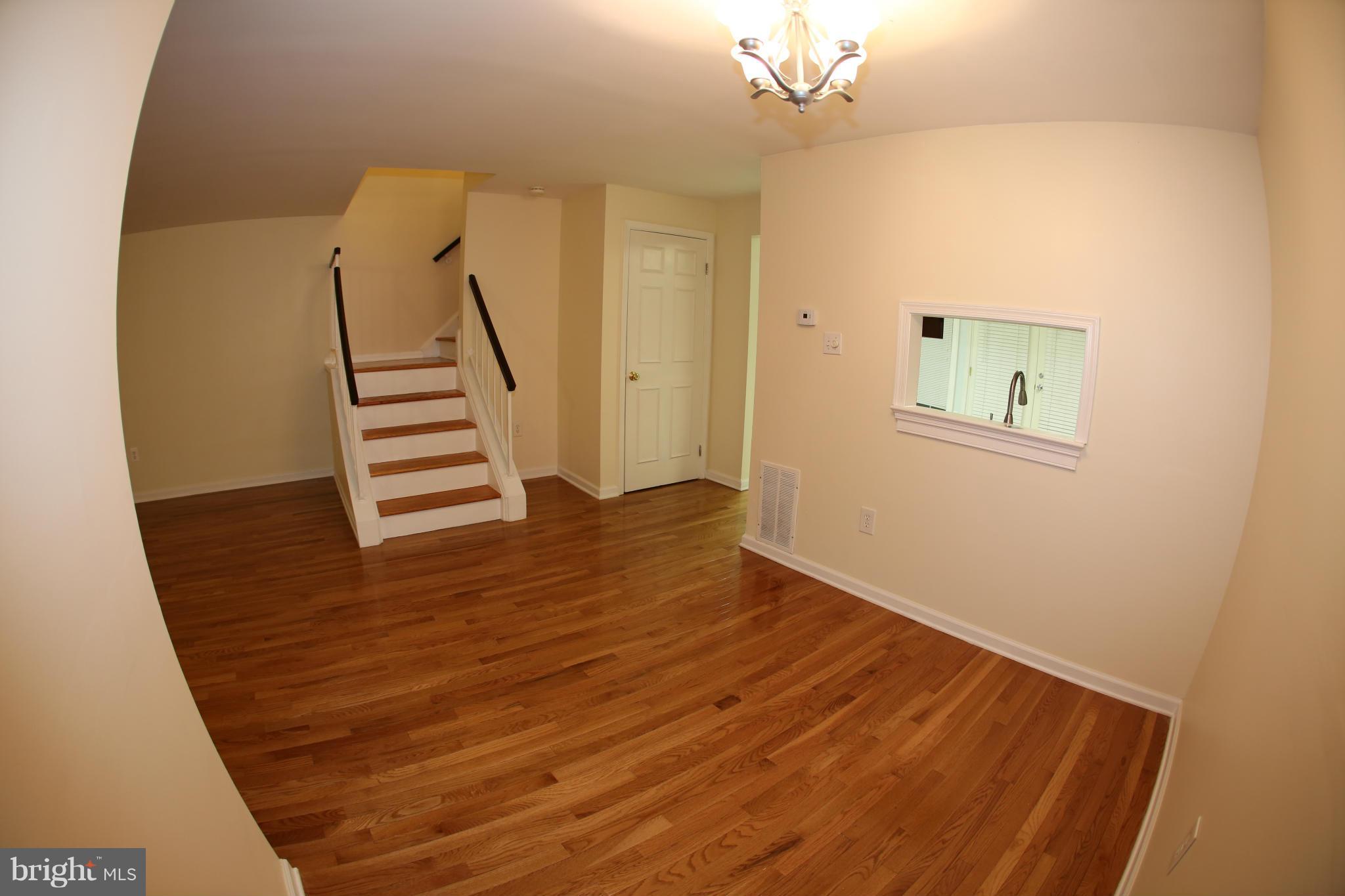 8046 Felecity Court Springfield, VA 22153 - Photo 5 of 26 a view of wooden floor and windows in a room