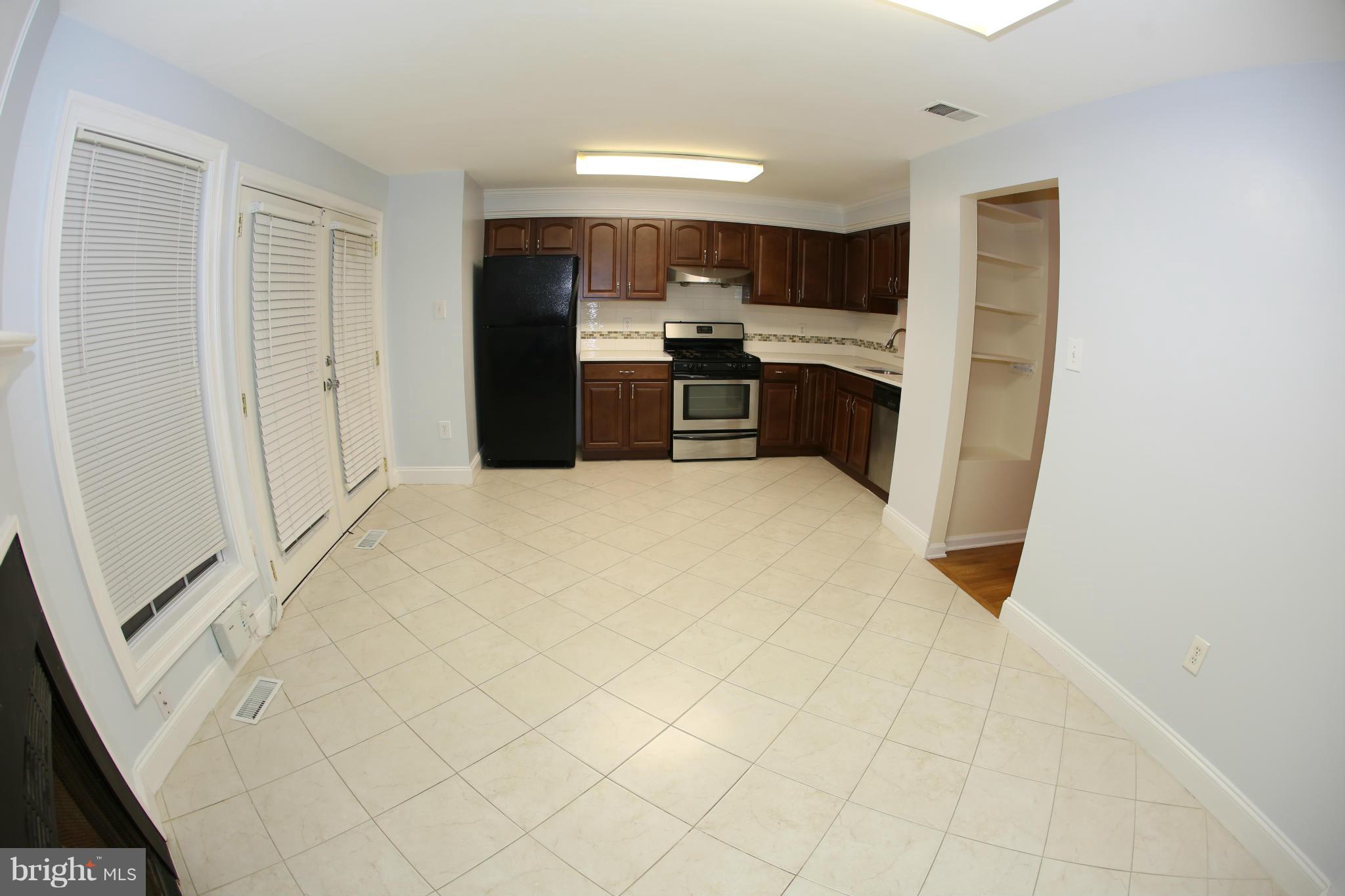 8046 Felecity Court Springfield, VA 22153 - Photo 7 of 26 a large white kitchen with cabinets and a refrigerator