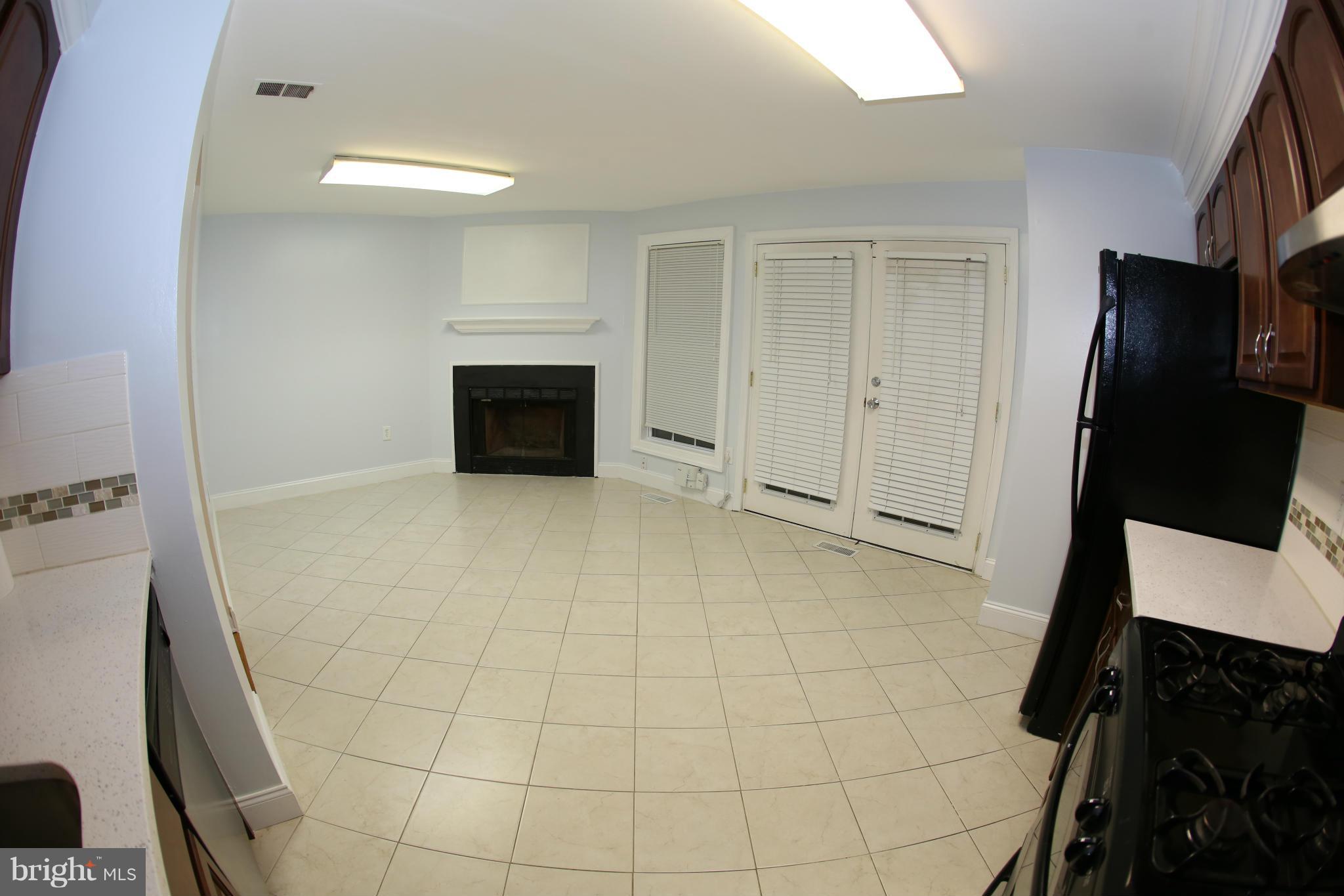 8046 Felecity Court Springfield, VA 22153 - Photo 9 of 26 a view of a livingroom with an empty space and a fireplace
