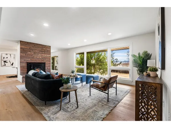 a living room with furniture rug and wooden floor