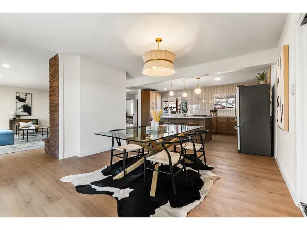 a view of a dining room with furniture and a potted plant