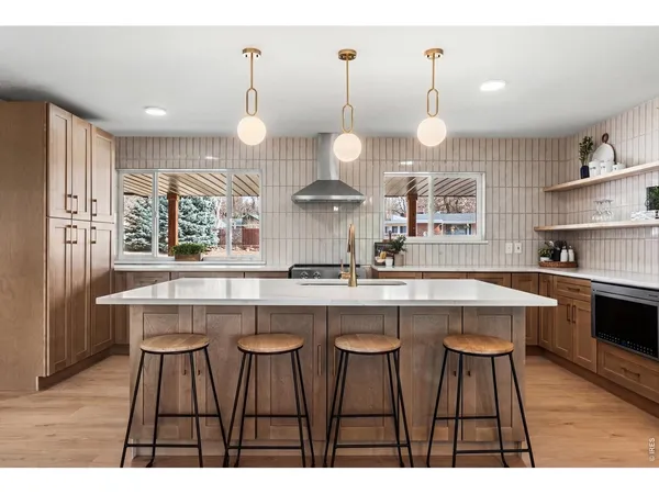 a kitchen with counter top space sink and stove