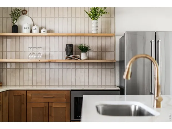 a kitchen with a sink and a potted plant