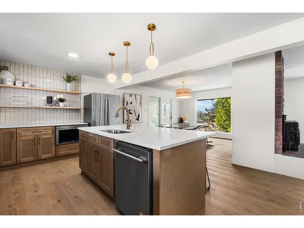 a kitchen with a table chairs sink and cabinets