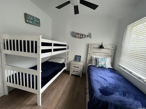 a bedroom with furniture and a window