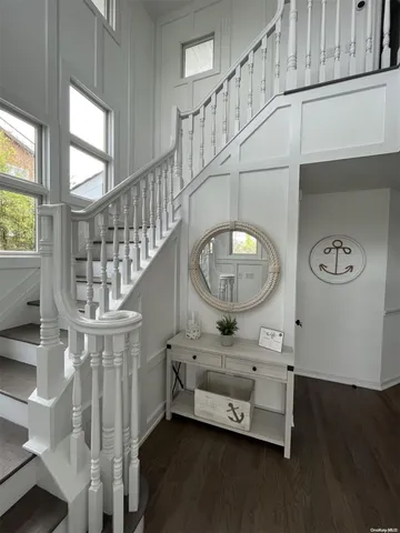 a view of entryway with a window and wooden floor