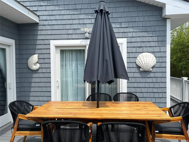 a view of a patio with a table and chairs