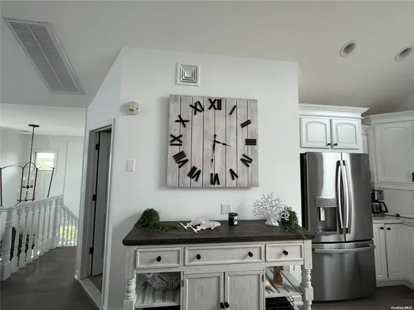 a kitchen with granite countertop a refrigerator and a sink