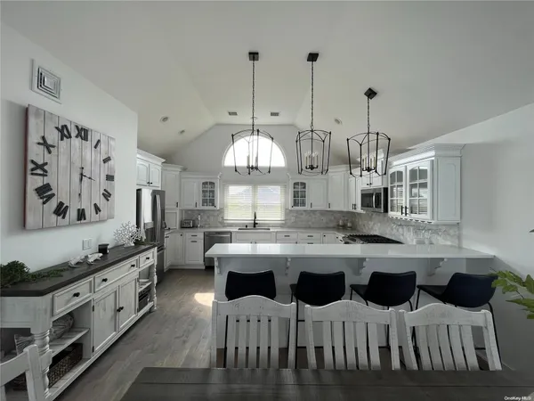 a kitchen with kitchen island granite countertop a sink and cabinets