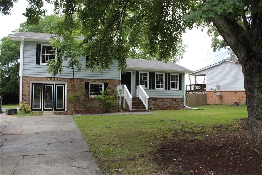 a front view of house with yard and green space