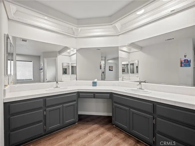 a view of double vanity sink a mirror and a window