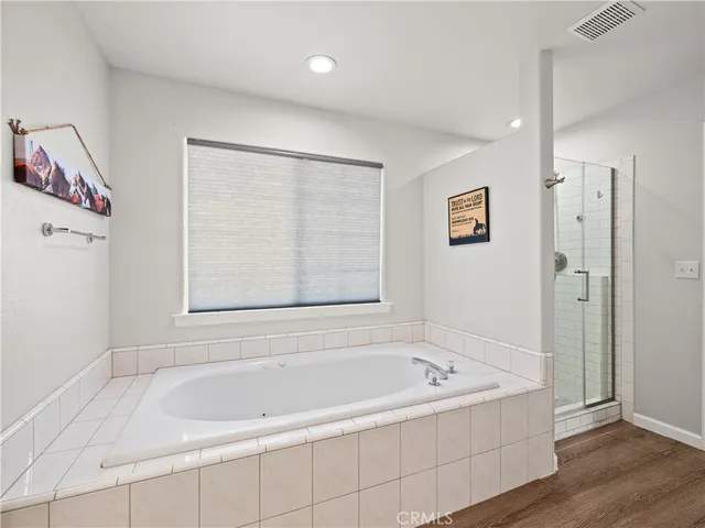 a bathroom with a bathtub and a shower