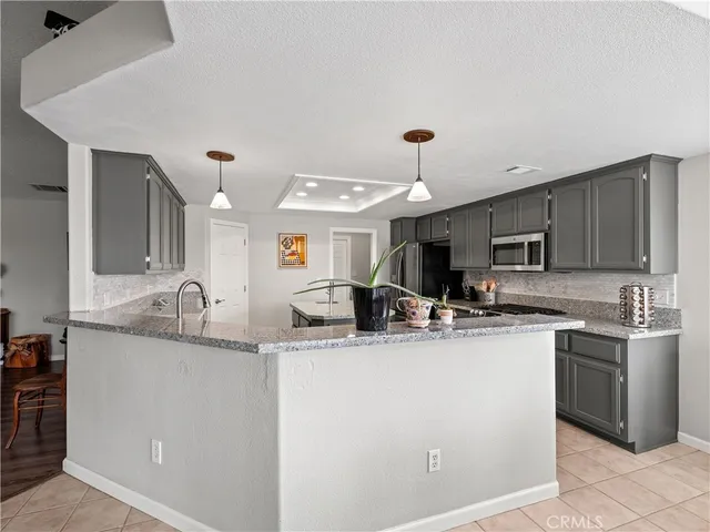 a kitchen with stainless steel appliances granite countertop a sink and cabinets
