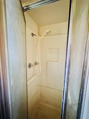 a bathroom with a glass shower door and a sink