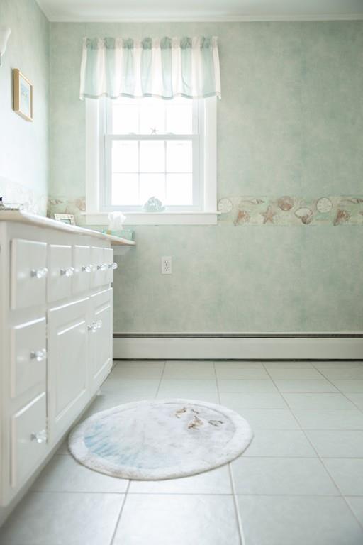 166 River Road Westport, MA 02790 - Photo 17 of 30 a bathroom with a window sink and a mirror
