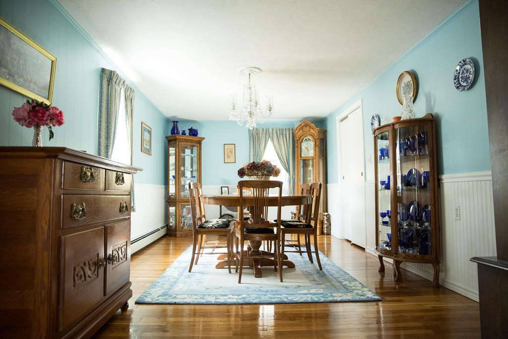 166 River Road Westport, MA 02790 - Photo 19 of 30 a dining room with furniture a chandelier and wooden floor