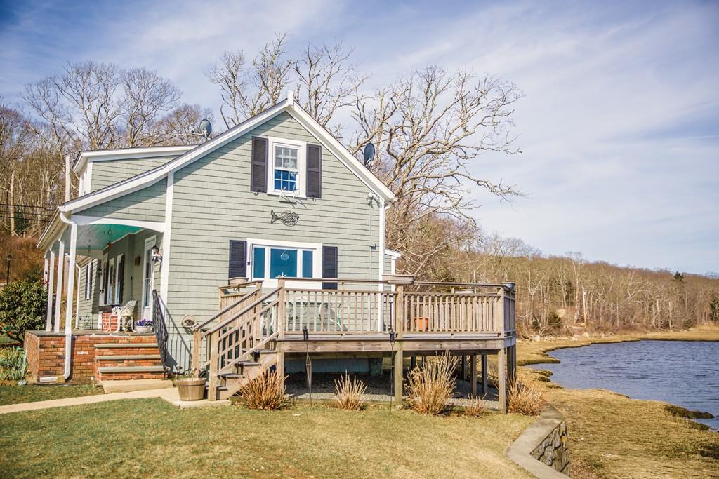 166 River Road Westport, MA 02790 - Photo 6 of 30 a view of a house with wooden deck and furniture