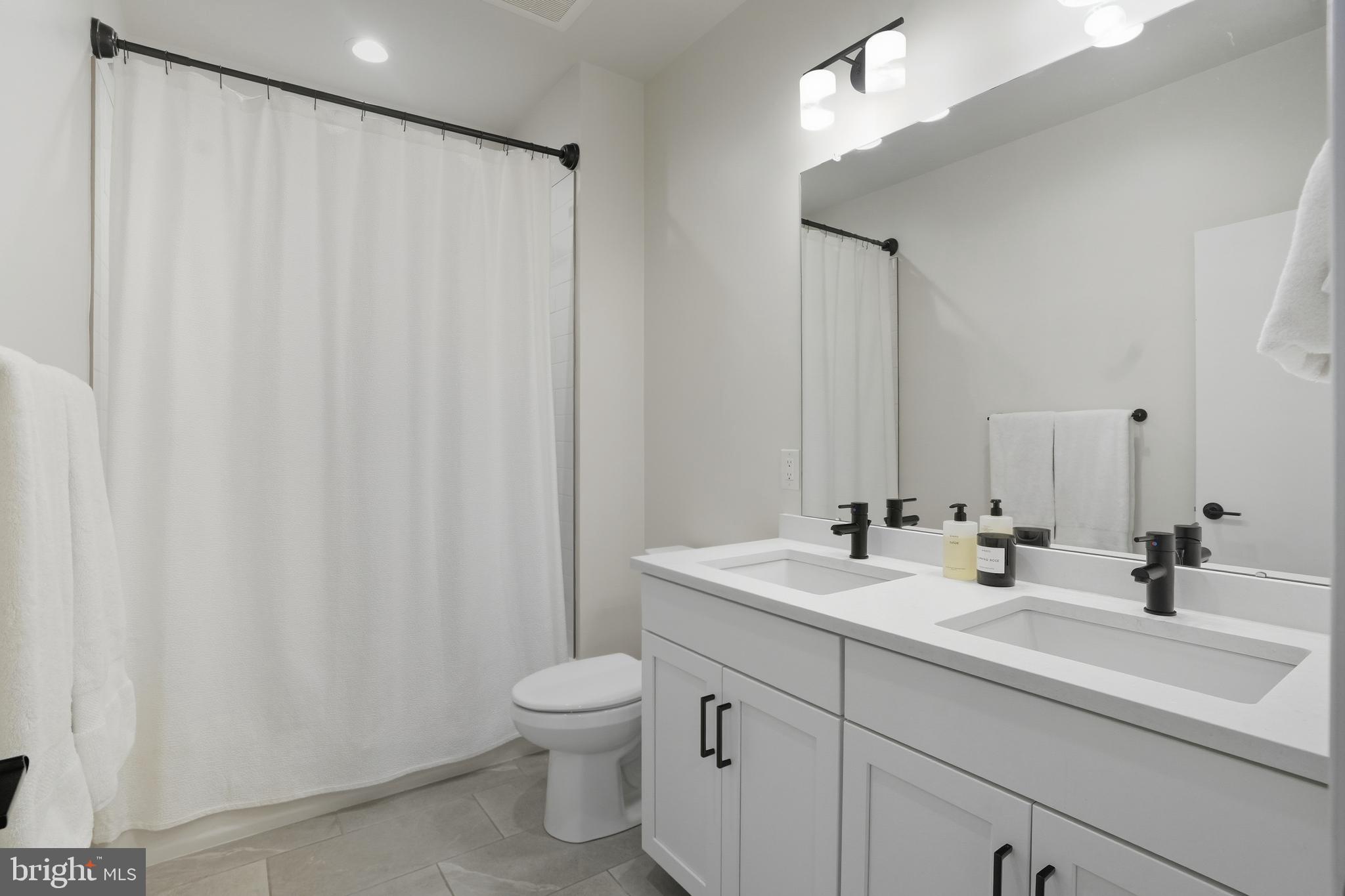 3112 Pierview Lane Philadelphia, PA 19125 - Photo 20 of 39 a bathroom with a double vanity sink and mirror