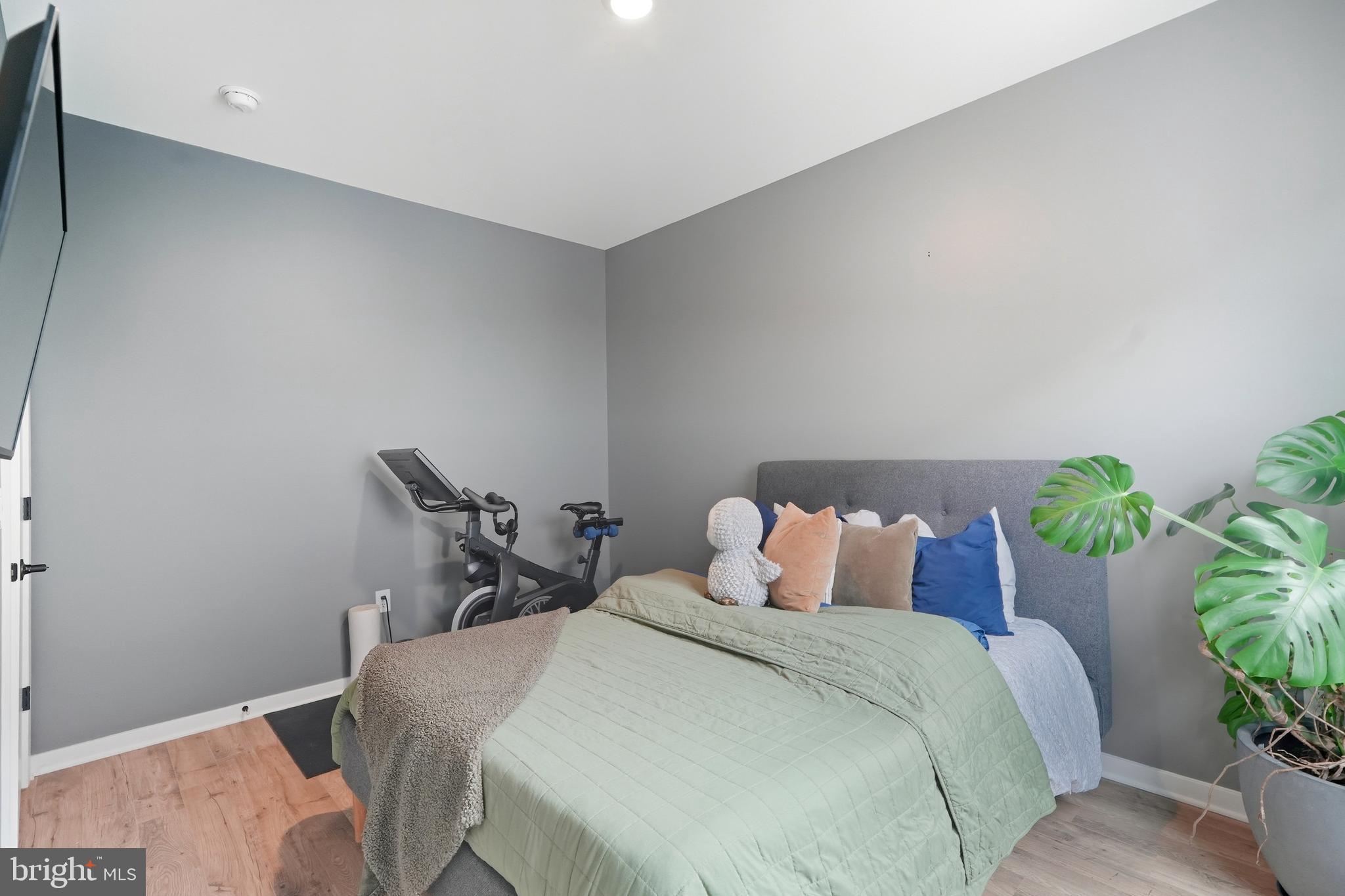 3112 Pierview Lane Philadelphia, PA 19125 - Photo 23 of 39 a bedroom with a bed and a potted plant