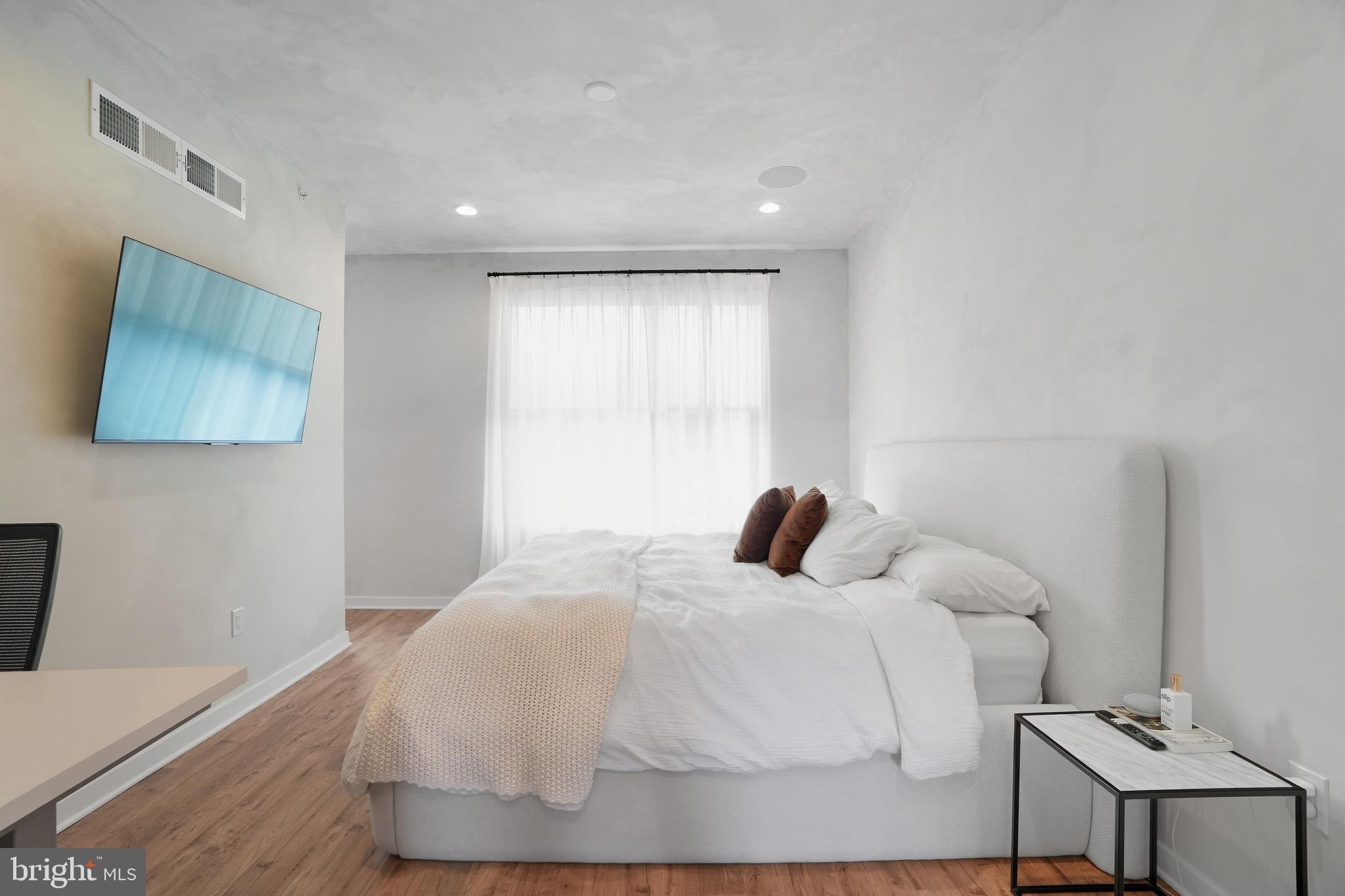 3112 Pierview Lane Philadelphia, PA 19125 - Photo 27 of 39 a bedroom with a bed and a night stand