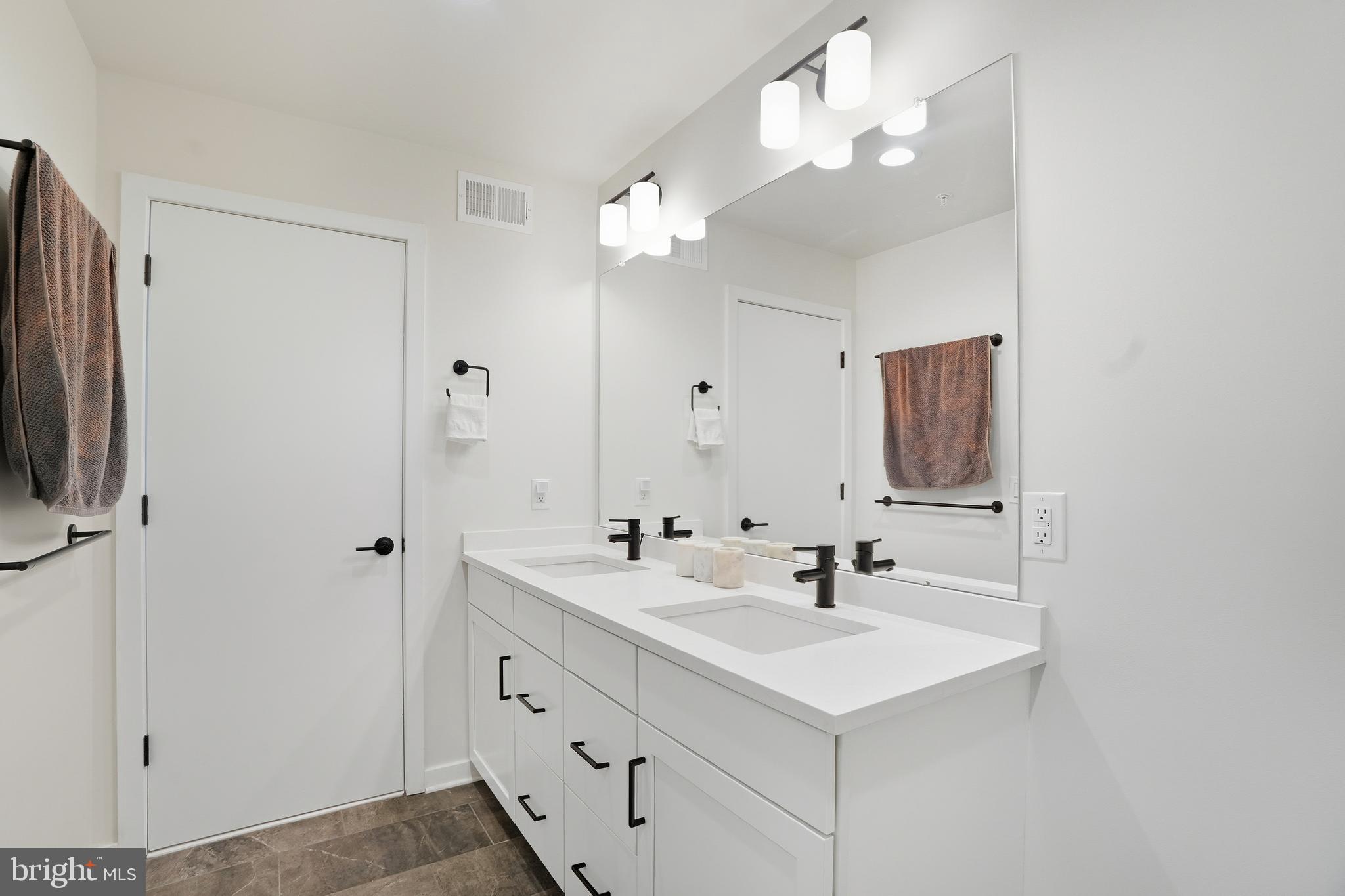 3112 Pierview Lane Philadelphia, PA 19125 - Photo 32 of 39 a bathroom with a sink a light fixture and a mirror