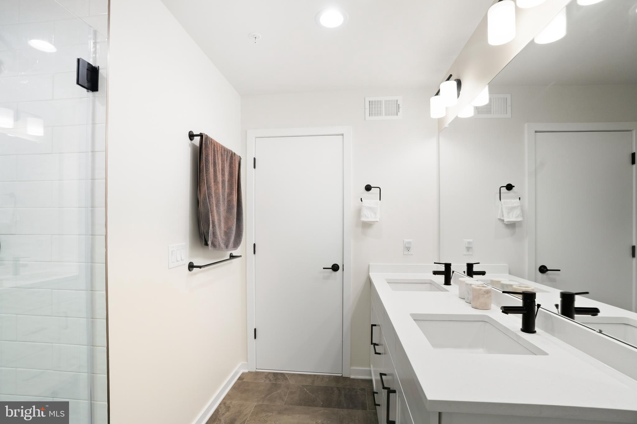 3112 Pierview Lane Philadelphia, PA 19125 - Photo 33 of 39 a bathroom with a sink a mirror and shower