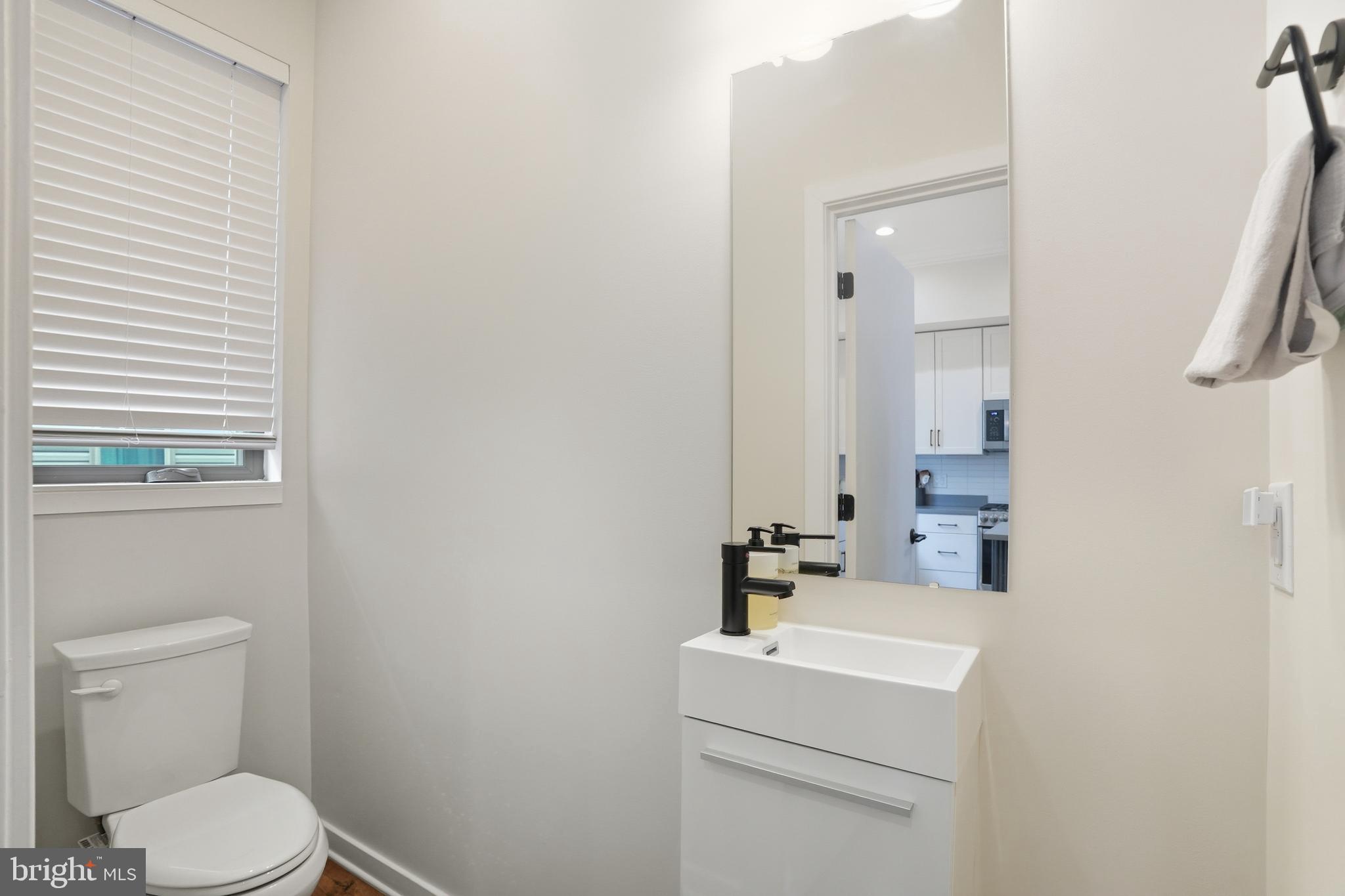 3112 Pierview Lane Philadelphia, PA 19125 - Photo 7 of 39 a bathroom with a sink a toilet and a mirror