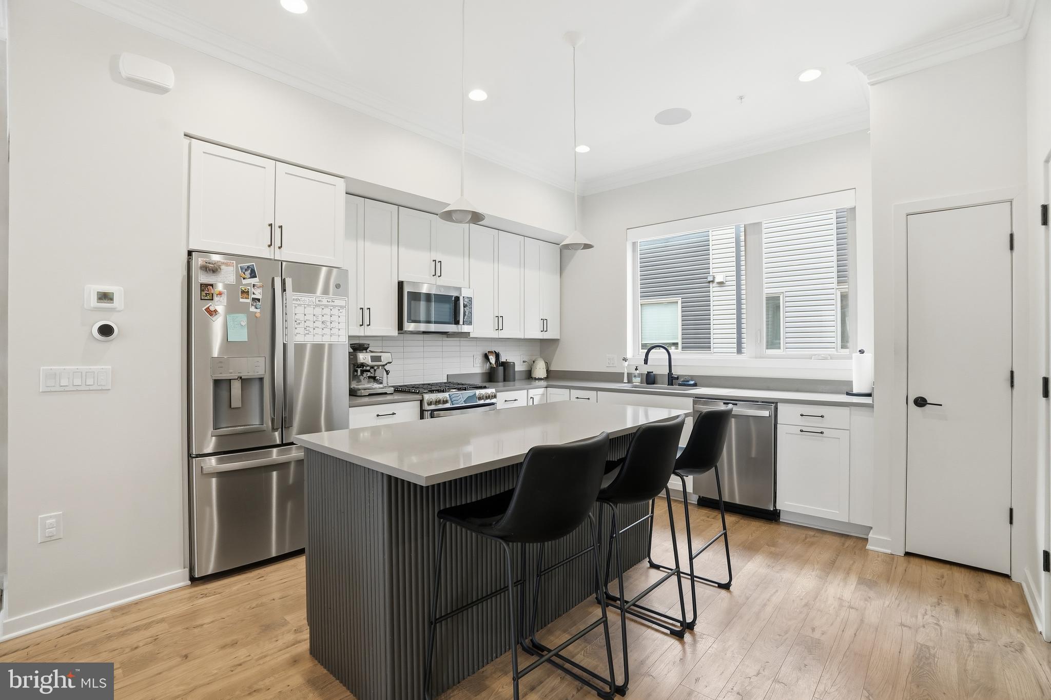 3112 Pierview Lane Philadelphia, PA 19125 - Photo 10 of 39 a kitchen with stainless steel appliances a sink a stove a refrigerator cabinets and a dining table