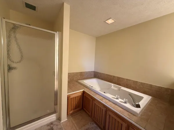 a bedroom with a bed and a ceiling fan