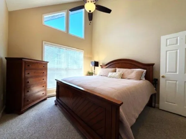 a bathroom with a granite countertop sink and a large mirror